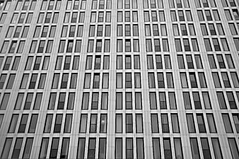 Black and white low-angle view of modern high-rise building facade
