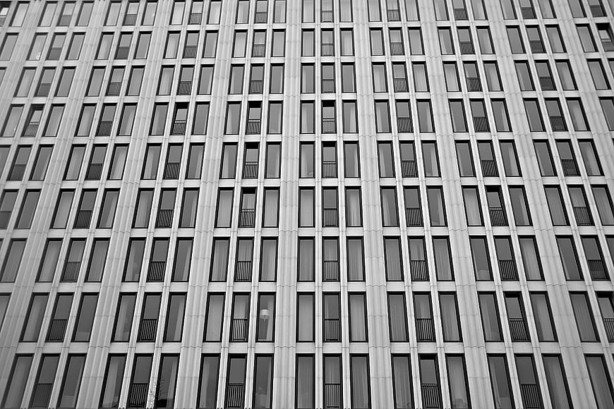 Black and white low-angle view of modern high-rise building facade