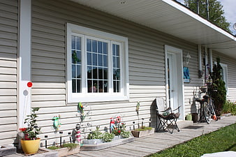 Cozy House Exterior with Decorated Wooden Deck and Garden