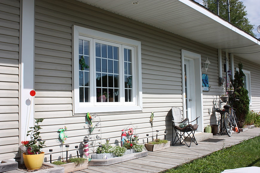 Cozy House Exterior with Decorated Wooden Deck and Garden
