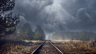 Dramatic Railway Tracks Leading Into Stormy Forest Landscape