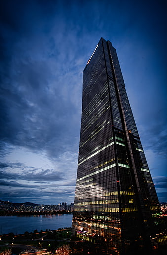 Modern Skyscraper at Dusk with Dramatic Blue Sky