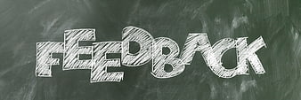 Feedback word written in white chalk on a green blackboard