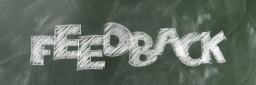 Feedback word written in white chalk on a green blackboard