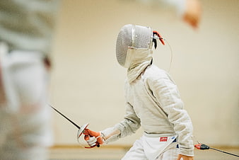 Young Fencer in Action with Sword and Mask