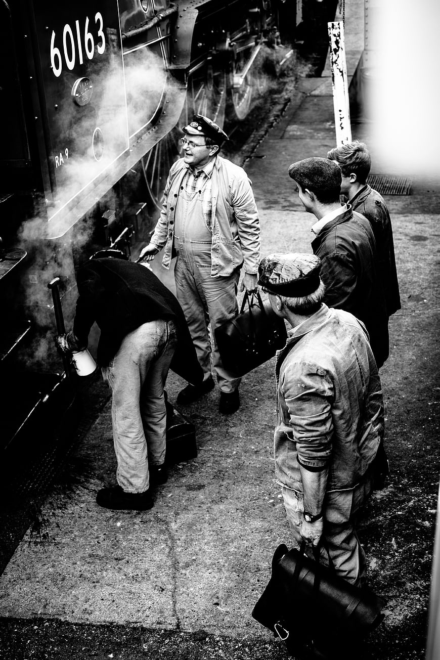 Vintage Black and White Photo of Men Waiting by Steam Train