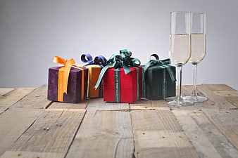 Colorful Gift Boxes and Champagne on Rustic Wood