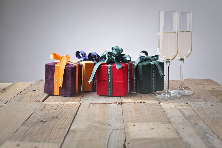 Colorful Gift Boxes and Champagne on Rustic Wood