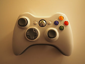 White Xbox 360 Controller on Beige Background