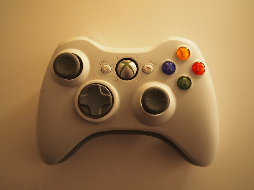 White Xbox 360 Controller on Beige Background