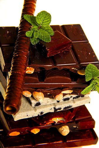 Stack of assorted chocolate bars with mint garnish