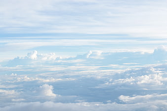 Aerial view of layered white clouds against a blue sky