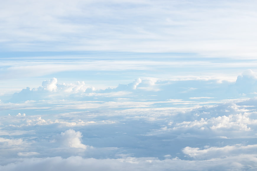 Aerial view of layered white clouds against a blue sky