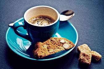Blue Coffee Cup with Biscotti and Brown Sugar on Dark Table
