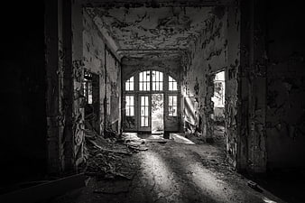 Abandoned Interior With Peeling Walls And Arched Window