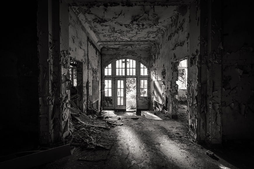 Abandoned Interior With Peeling Walls And Arched Window