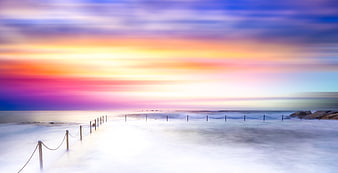Vibrant Long Exposure Sunset Over Misty Ocean Beach