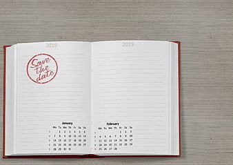 Open 2019 Planner Notebook With Save The Date Stamp On Gray Background