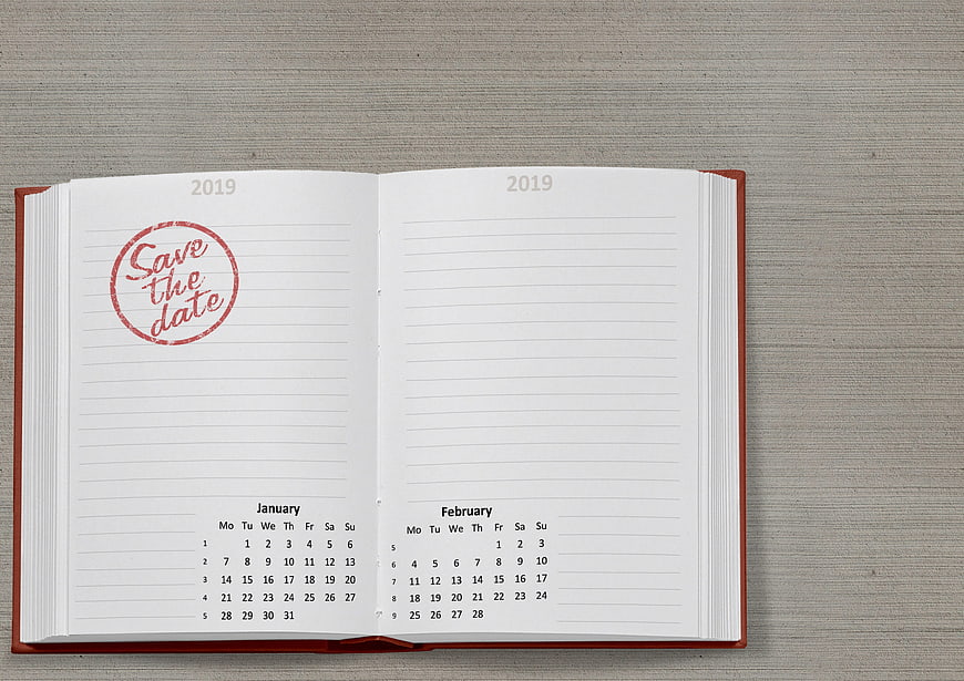 Open 2019 Planner Notebook With Save The Date Stamp On Gray Background