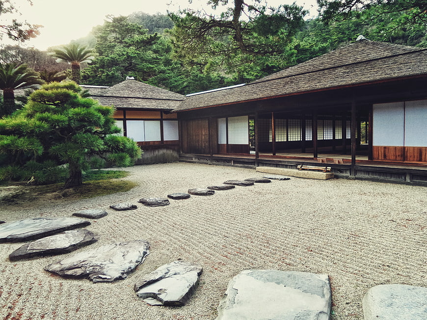 Traditional Japanese Garden with Raked Gravel and Stone Path