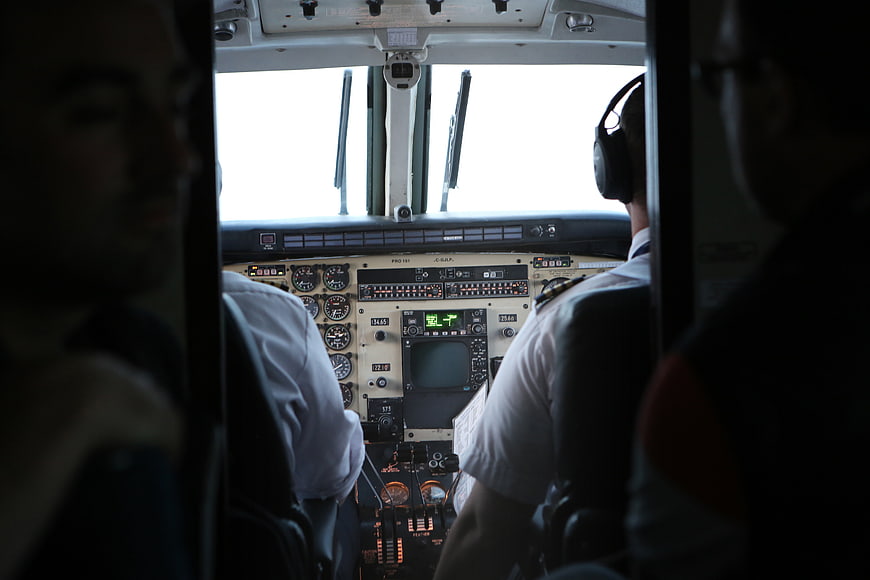 Pilots in Airplane Cockpit with Instrument Panel