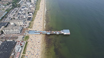 Aerial View of Busy Beach and Pier with Ocean