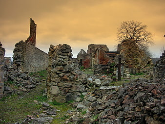 Ruins of Oradour-sur-Glane Martyr Village Under Dramatic Golden Sky