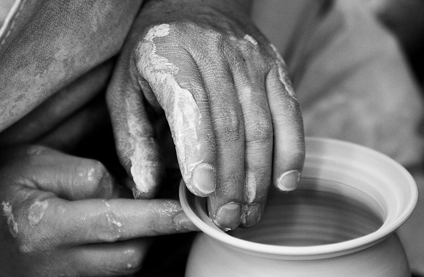 Close-up of Hands Shaping Clay Pot on Wheel