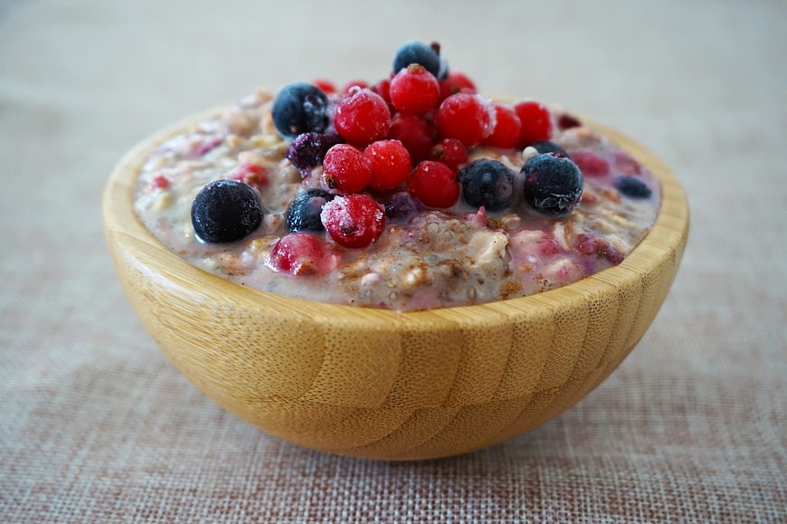 Healthy Overnight Oats With Fresh Berries In Wooden Bowl