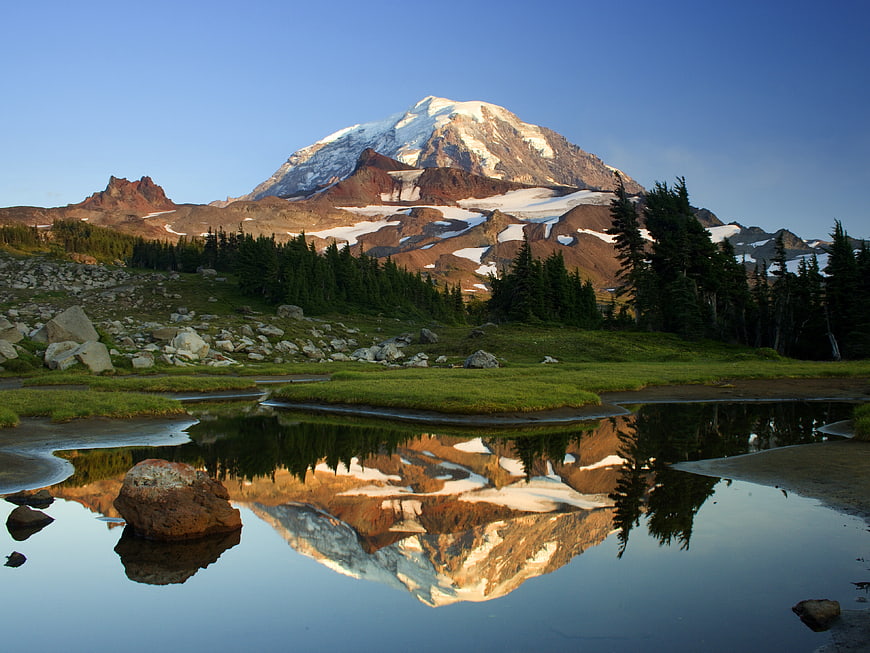 Majestic snow-capped mountain reflected in a serene alpine lake