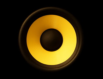 Close-up of yellow speaker cone on black background