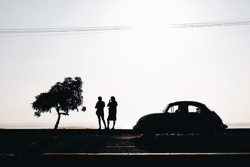Silhouette of Volkswagen Beetle and Couple by the Sea