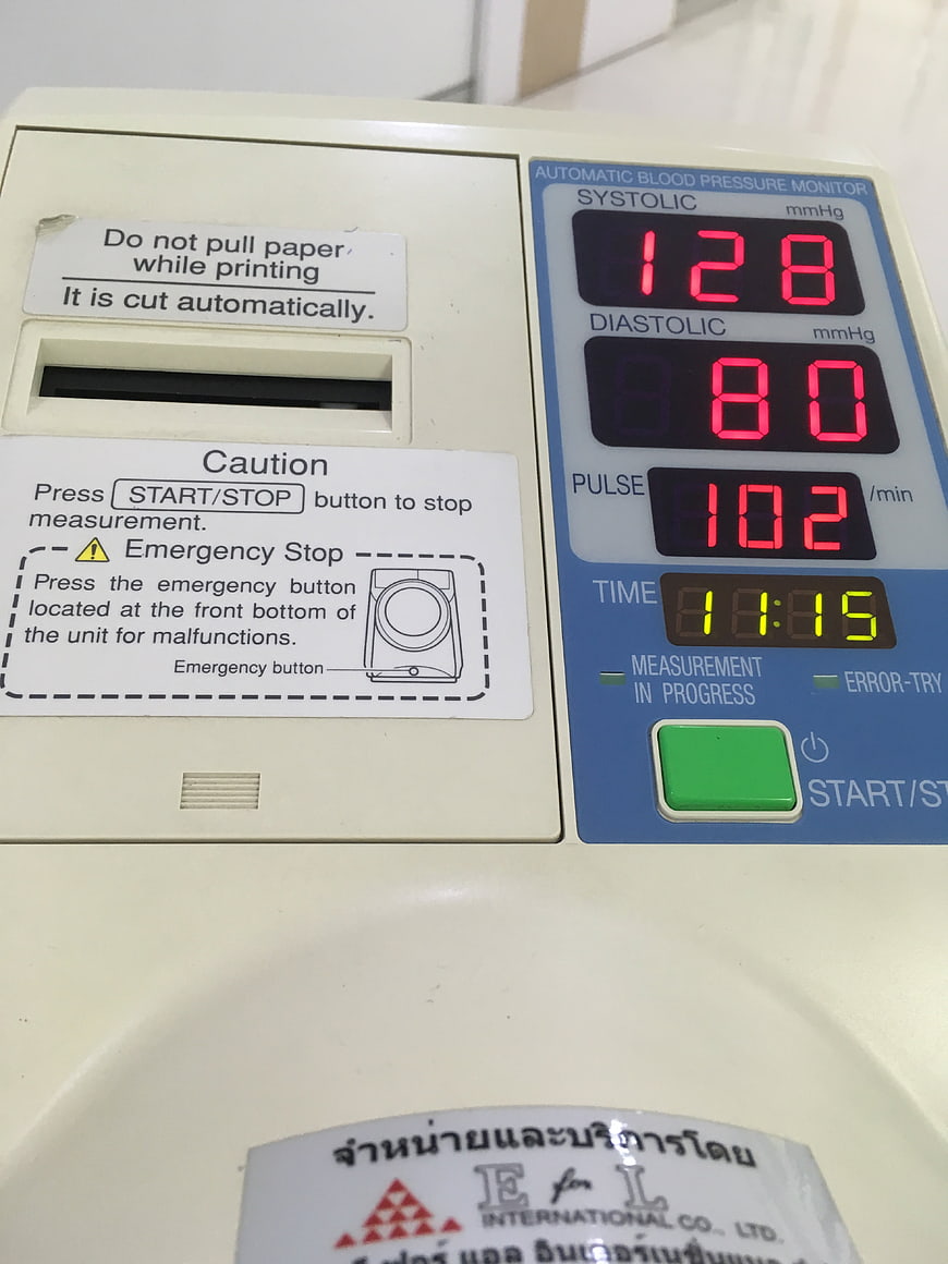 Close-up of digital automatic blood pressure monitor displaying readings