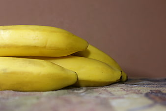 Close-up of ripe yellow bananas on a textured surface