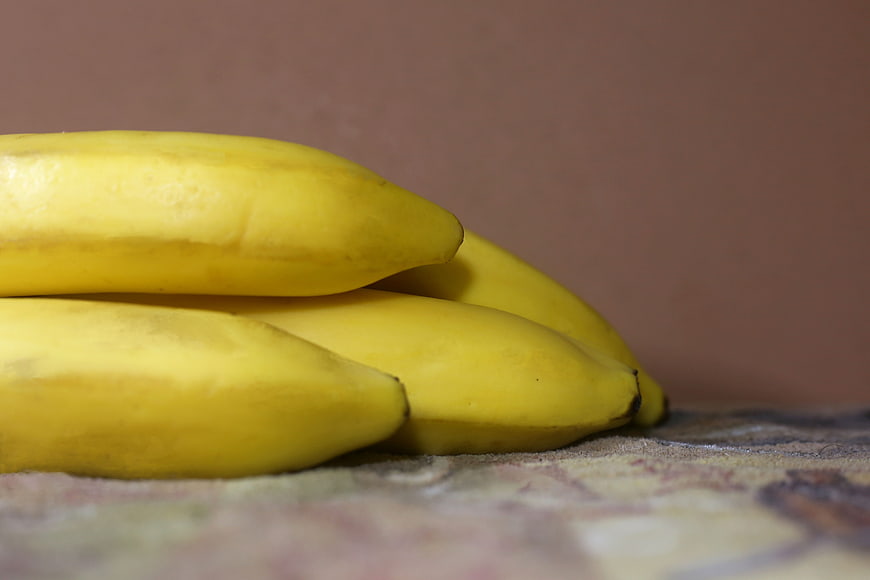 Close-up of ripe yellow bananas on a textured surface