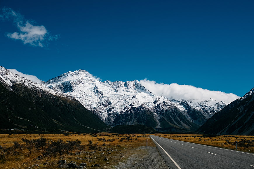 Scenic Mountain Road Leading to Snowy Peaks