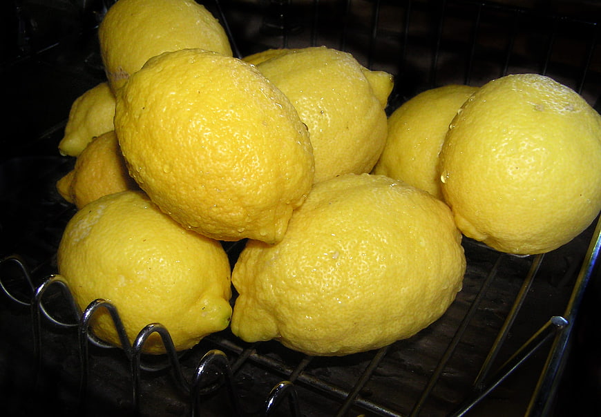 Fresh Yellow Lemons with Water Drops in Wire Basket