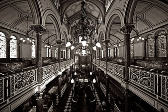 Black and white interior of ornate synagogue with chandelier