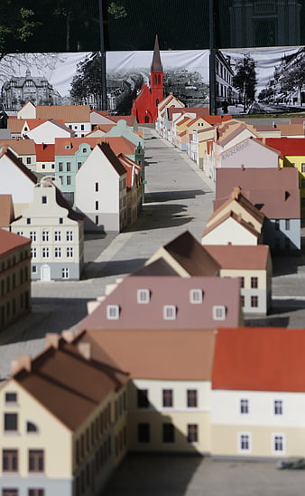 Miniature model town with red church and historical backdrop
