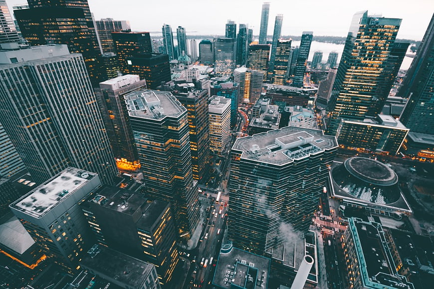 Aerial View of Downtown Cityscape at Dusk with Illuminated Skyscrapers