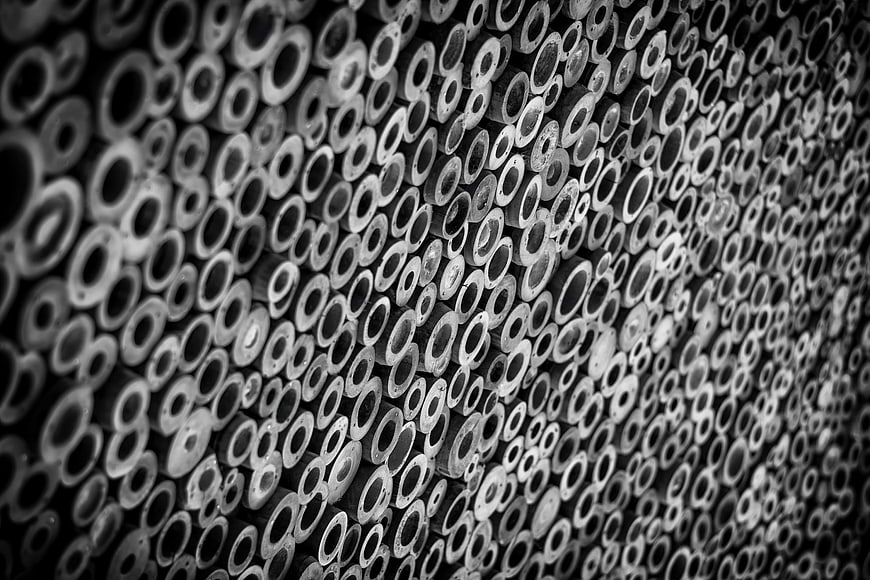 Black and white pattern of stacked bamboo logs