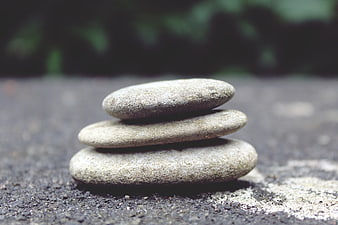 Stacked Zen Stones on Rough Concrete Surface