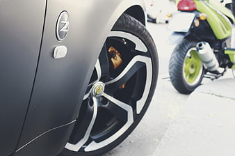 Close-up of matte black car wheel with gold brake caliper