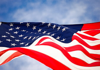 American Flag Waving Against Blue Sky