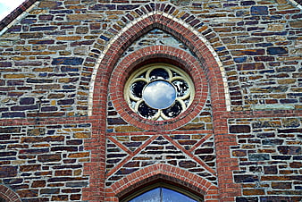 Gothic Rose Window on Historic Stone and Brick Church Facade