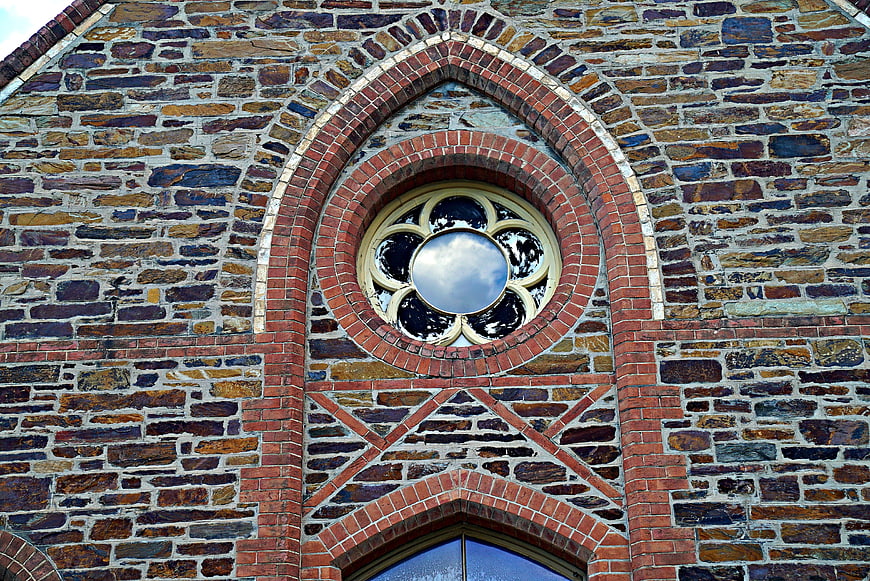 Gothic Rose Window on Historic Stone and Brick Church Facade