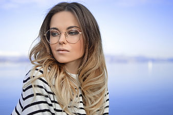 Portrait of Woman with Glasses and Striped Shirt by Water