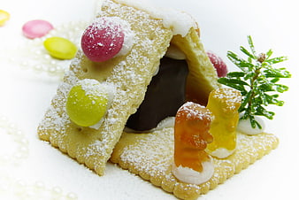 Miniature Biscuit House with Gummy Bears and Powdered Sugar