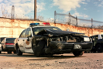 Damaged police car after crash in parking lot