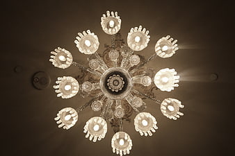 Low angle view of ornate crystal chandelier with warm lighting